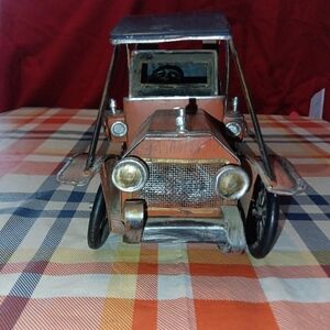Silver and Brown Vintage Pedal Car with Streamlined Design